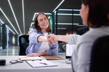 Success in Negotiation: Businesswoman Shakes Hands With...