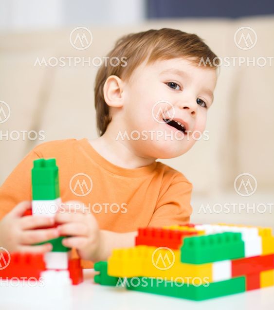 Boy is playing with building blocks