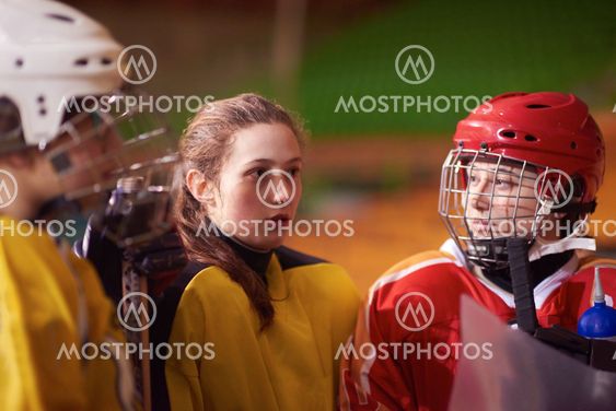 teen ice hockey players team meeting with trainer