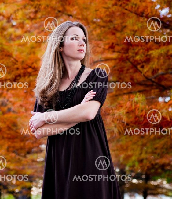 Beautiful woman in autumn foliage