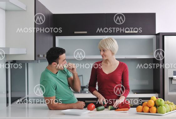 young couple have fun in modern kitchen