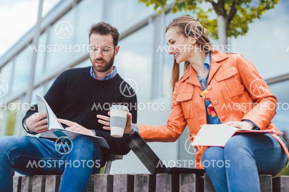 Woman and man studying together on university campus