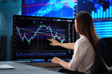 Focused businesswoman analyzes stock market data