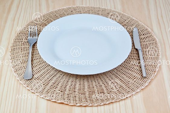Elegant dish fork knife on braided cloth. On the texture...