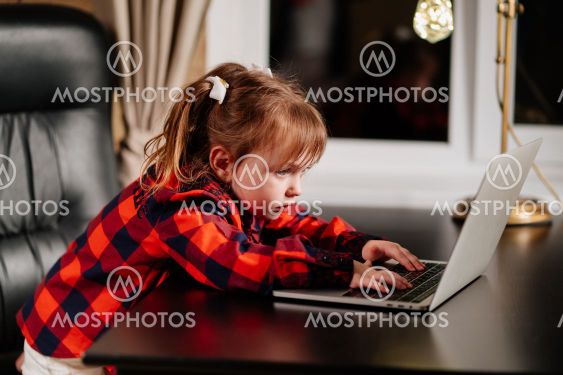 a little girl imitates her mother and works on a...