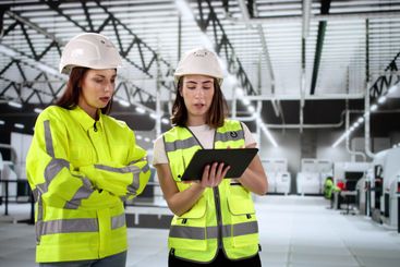 Female engineer inspects factory using tablet
