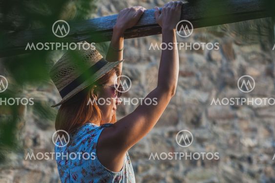 Young woman enjoying sunset at balcony