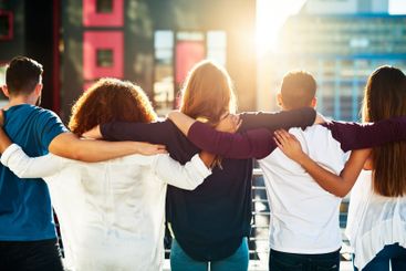 Back, people and city with hug on balcony for holiday,...