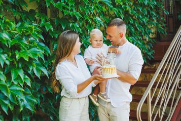 Mom and dad in nature with their one-year-old son...