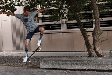 City, jump and man with skateboard, practice and skills...