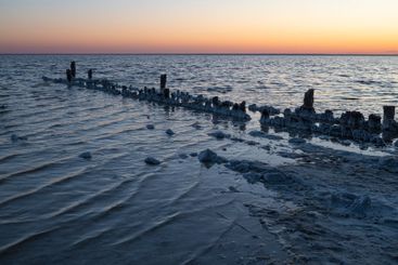 Evening at the old pier. Salt lake of Elton