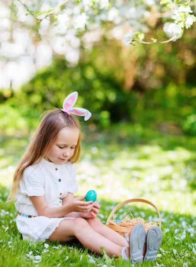 Little girl playing with Easter eggs