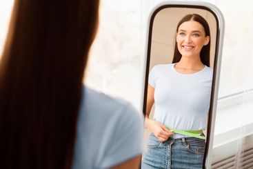 Happy Woman After Slimming Measuring Waist With Tape...