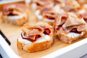 Delicious elegant bruschetta with meat and butter. A...