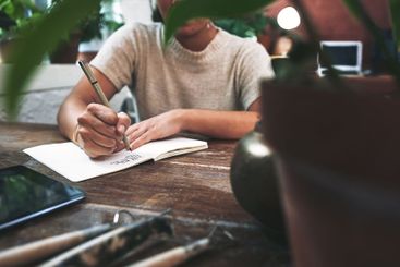 Pottery, hands and person with writing in workshop for...