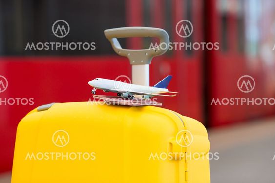 Closeup red passports and airplane small model on yellow...