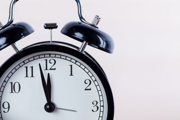 Close up of a black old-fashioned alarm clock