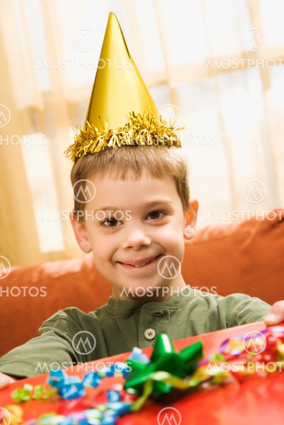Boy holding birthday gift.