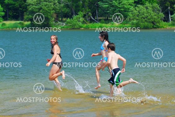 Children running into water
