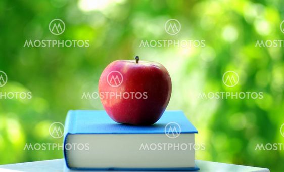 red apple on a book