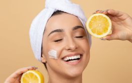 Young woman enjoying a skincare routine with fresh lemons...