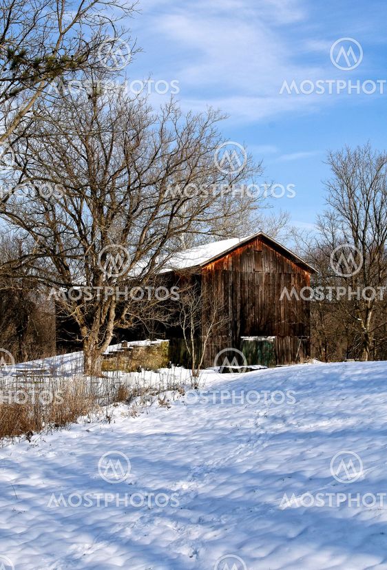 Old weathered barn in winter
