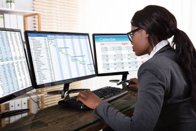 Businesswoman Analyzing Gantt Chart On Computer