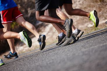 Shoes, legs and people with running in road for marathon...