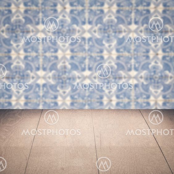 Wood table top and blur vintage ceramic tile pattern wall