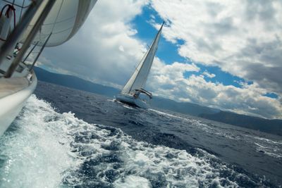 Sailing over the ocean waves in stormy weather. 