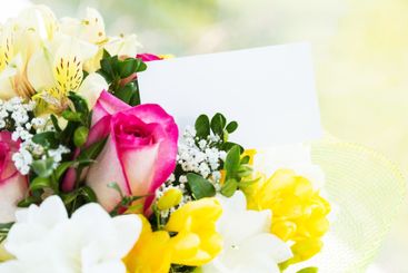 Colorful bouquet of flowers with a blank card displayed...