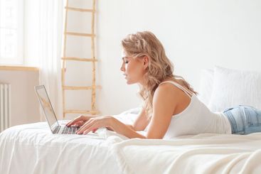 Attractive young woman working with laptop at home