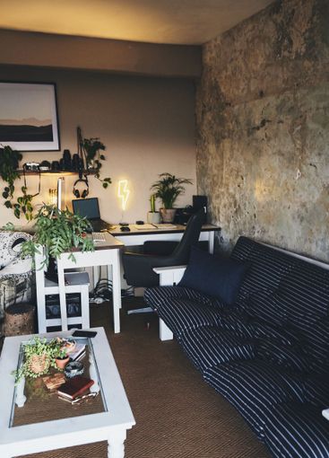 Sofa, home office and laptop on desk for interior...