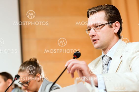 Portrait of a business man with microphone