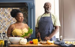 Happy senior african american couple wearing aprons and cook