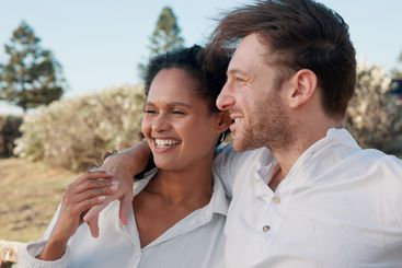 Relax, interracial couple and happy together outdoor for...