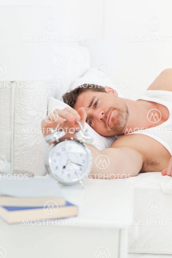 A unhappy man in his bed before waking up