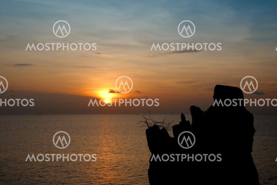 A lone rock in the sea sunset