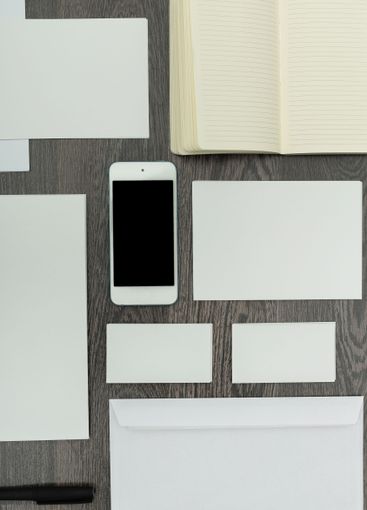 Various office supplies arranged neatly on a wooden...