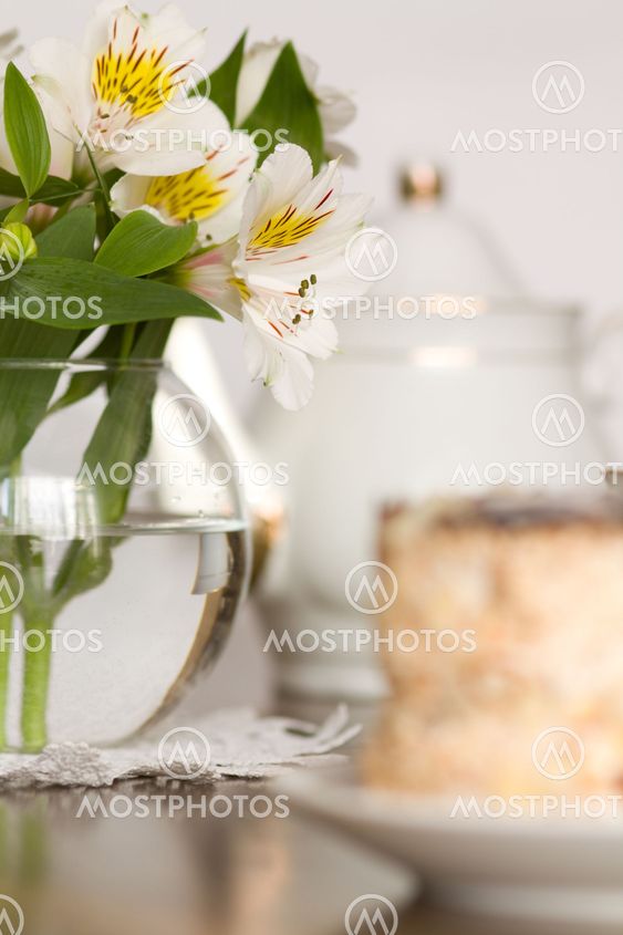 Delicate flower in glass vase on wooden table