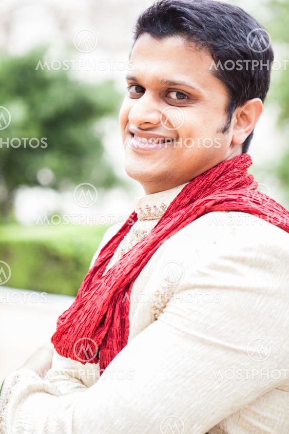 Handsome Indian groom in traditional attire at wedding