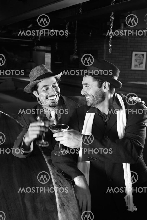 Men drinking at bar.