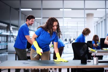 Diverse cleaning team professionally services office...