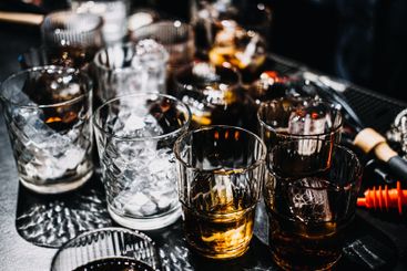 Whiskey Cocktail with Ice Sphere in a Moody Bar Setting