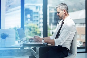 Business, man and typing on laptop in office for company...