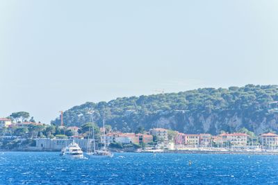 Daylight view to white yachts and boats cruising on water