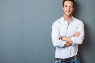 Portrait Of Smart Man Against gray background