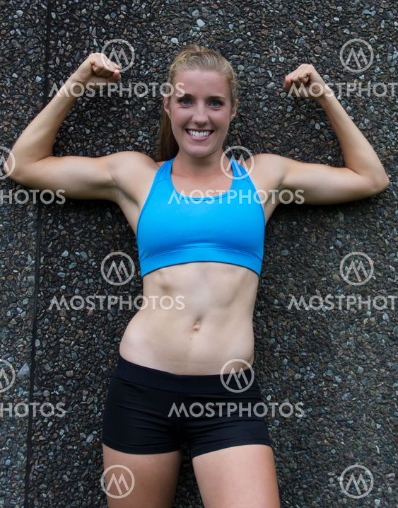 Fit, sexy woman flexing her biceps