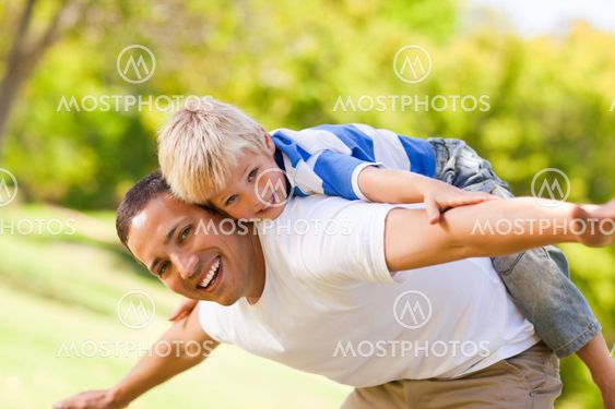 Son playing with his father in the park