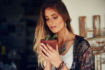 Woman, pot plant and garden in backyard for growth,...